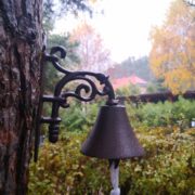 dzwonek żeliwny na drzewie